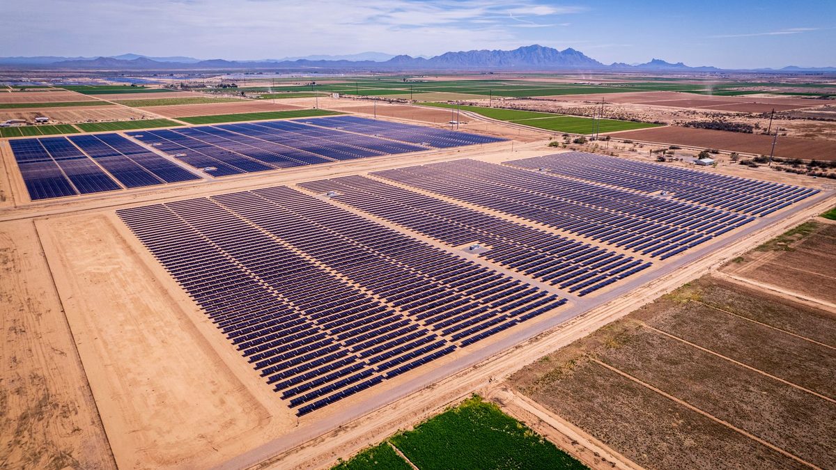 Representative image: aerial view of a large single-axis tracker solar farm on dry, open land
